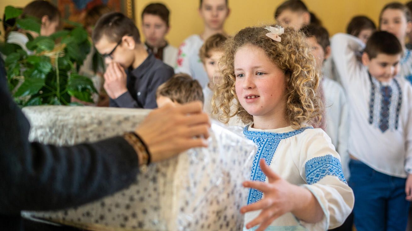 image:Image Máme znamení Boží velkorysosti a snažíme se ji napodobovat – jsme přece jeho obrazem. Na fotografii je dívenka, která dostává dárek při akci olomoucké Charity „Vánoční balíček pro Ukrajinu“.